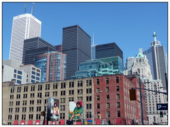 Downtown Toronto skyline near 151 Front Street, with office towers behind a row of older brick buildings